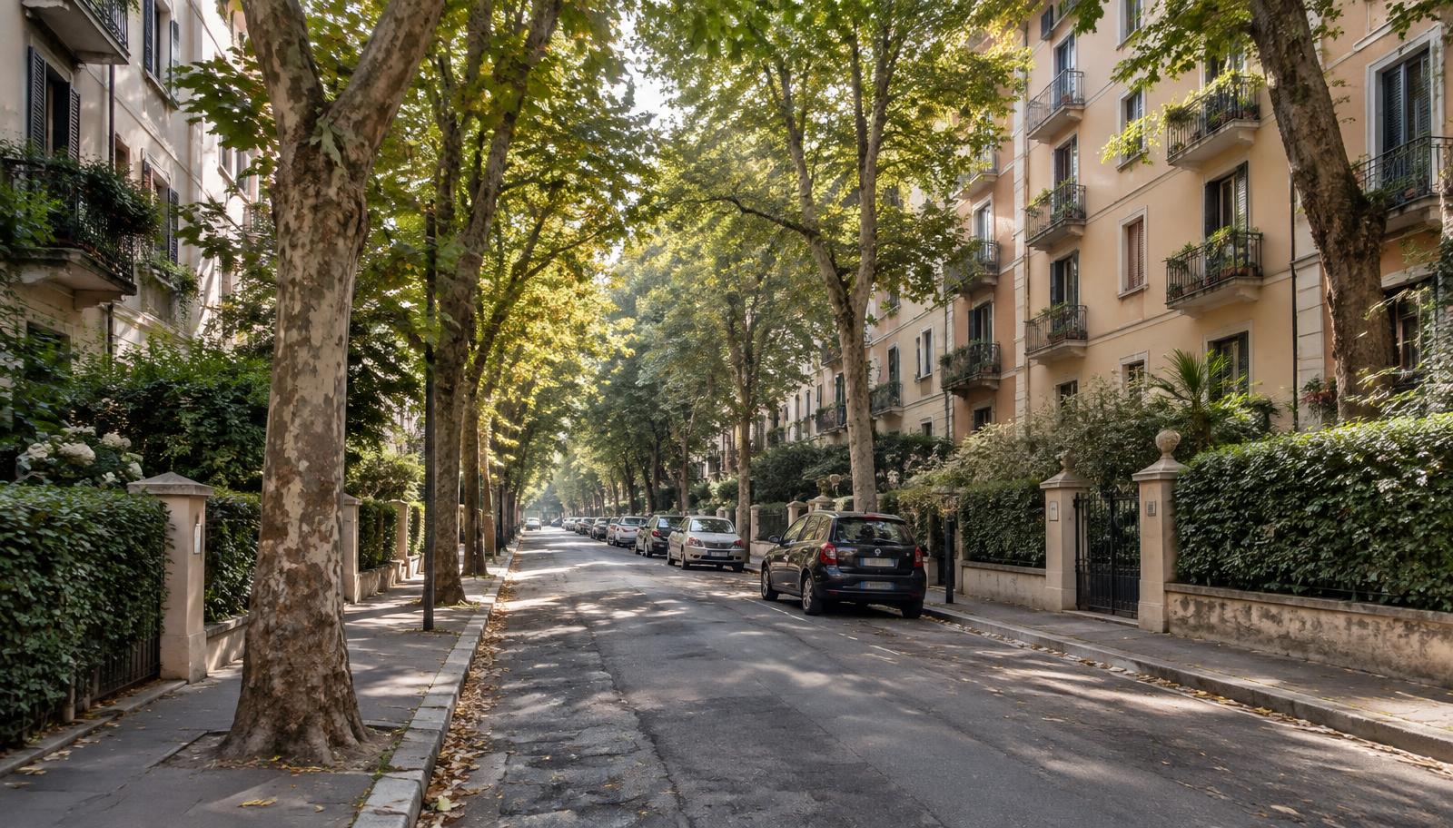 Leafy residential street with mature trees, apartment blocks behind low hedges and parked cars